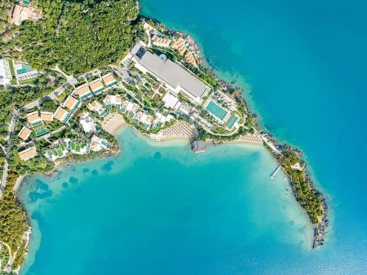 Overhead view of the Kommeno peninsula and the resort's pools and villas