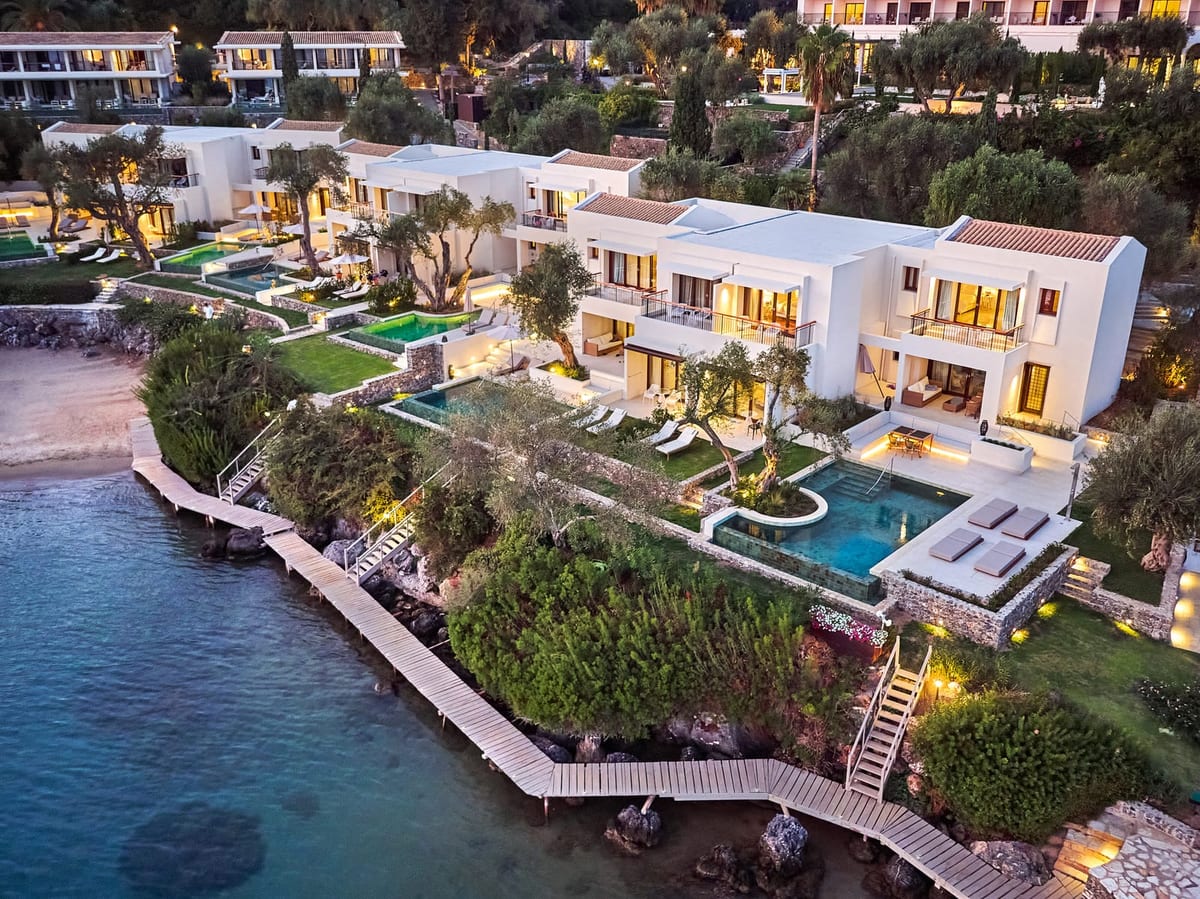 Waterfront villas with private pools and boardwalks at dusk