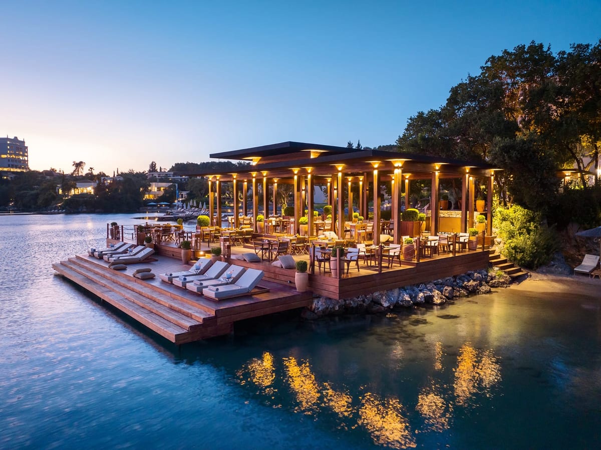 Yali Seafood restaurant lit on its deck over the water at dusk