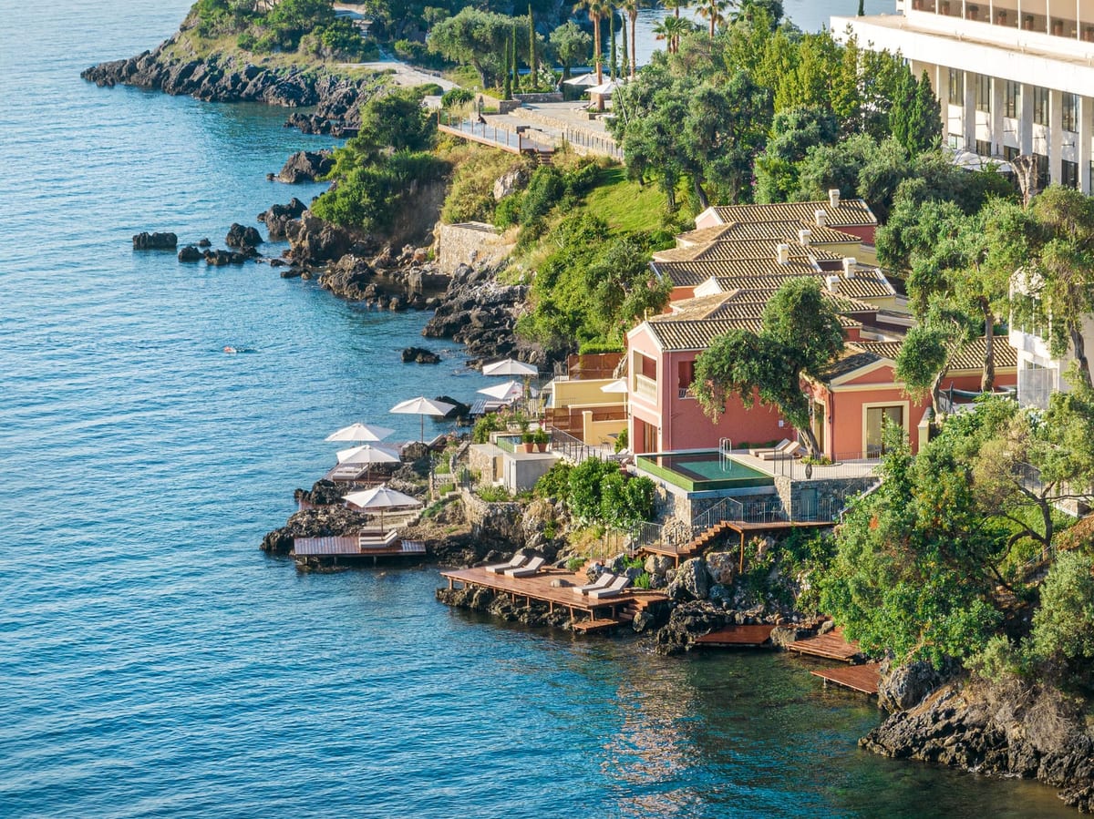 Terracotta palazzo villas on the rocks above deep water with sea decks